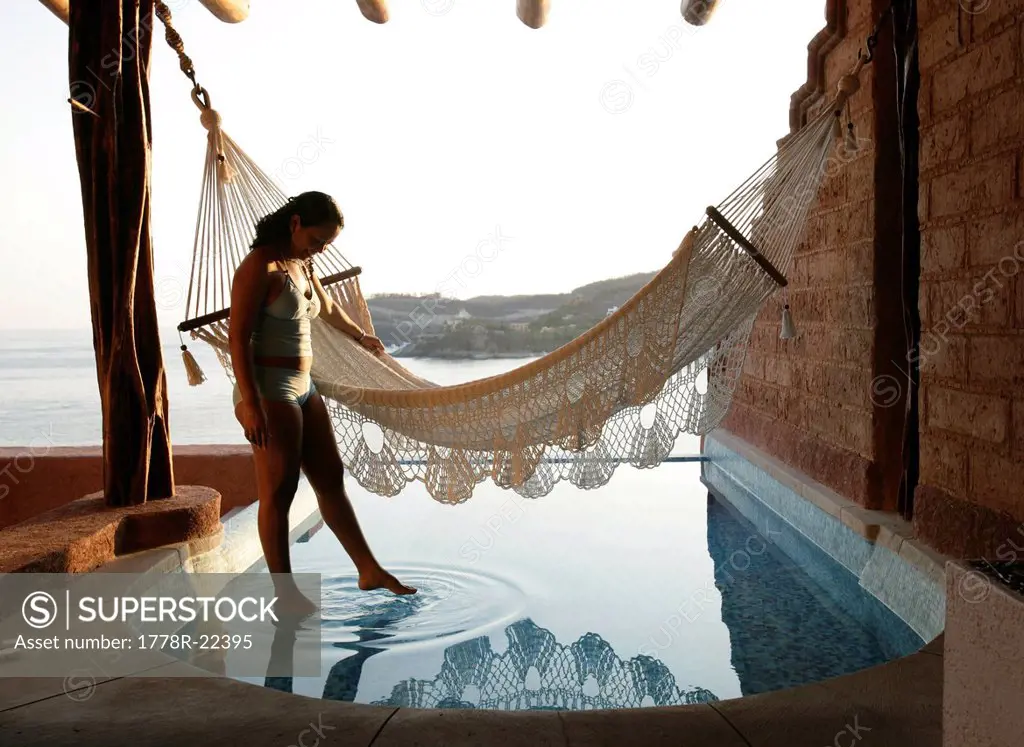 A woman stands next to a hammock in Mexico