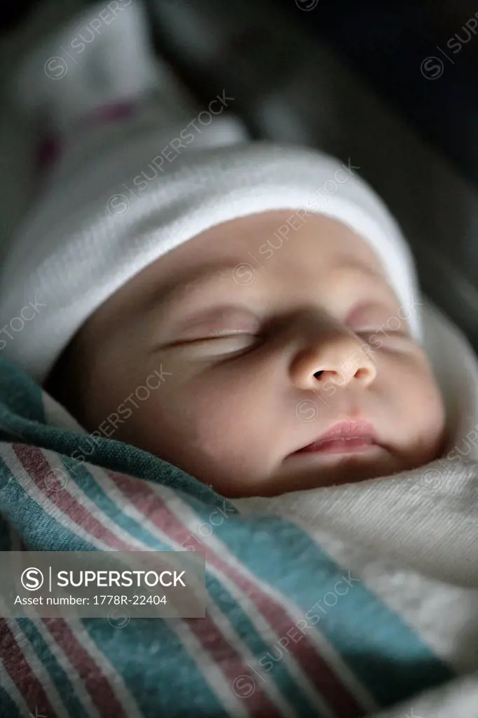 A sleeping newborn baby girl less than one day_old.