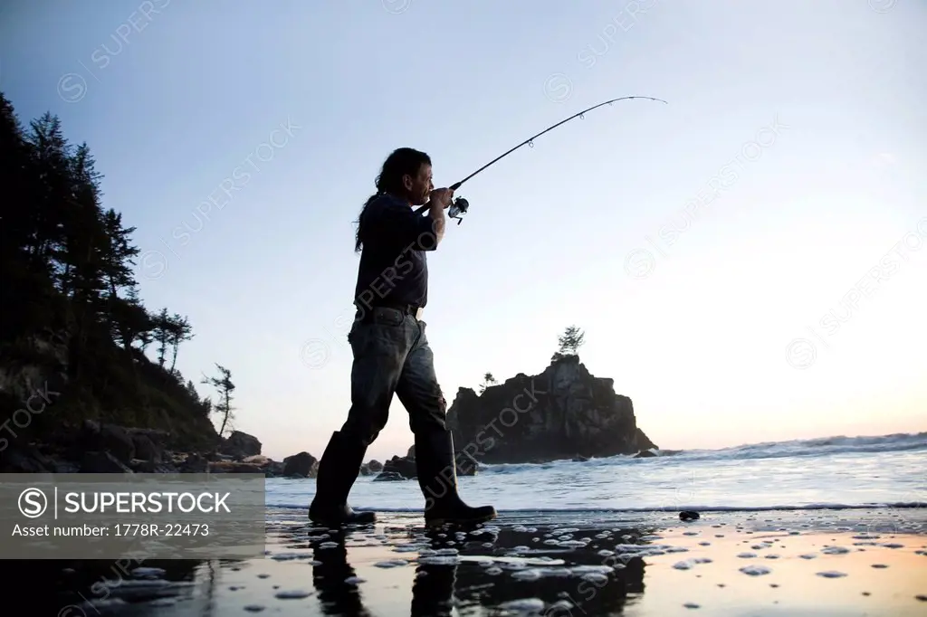 A man fishes off the coast of California near Redwood National Park.