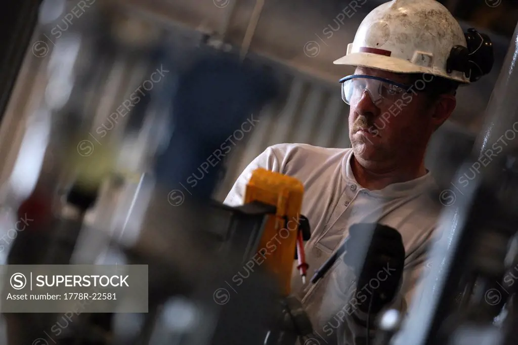 A natural gas plant technician in a hardhat.