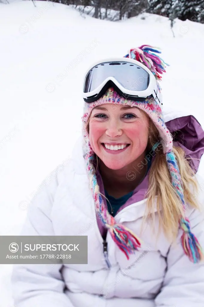 A happy young woman smiles while taking a break from skiing in Idaho.