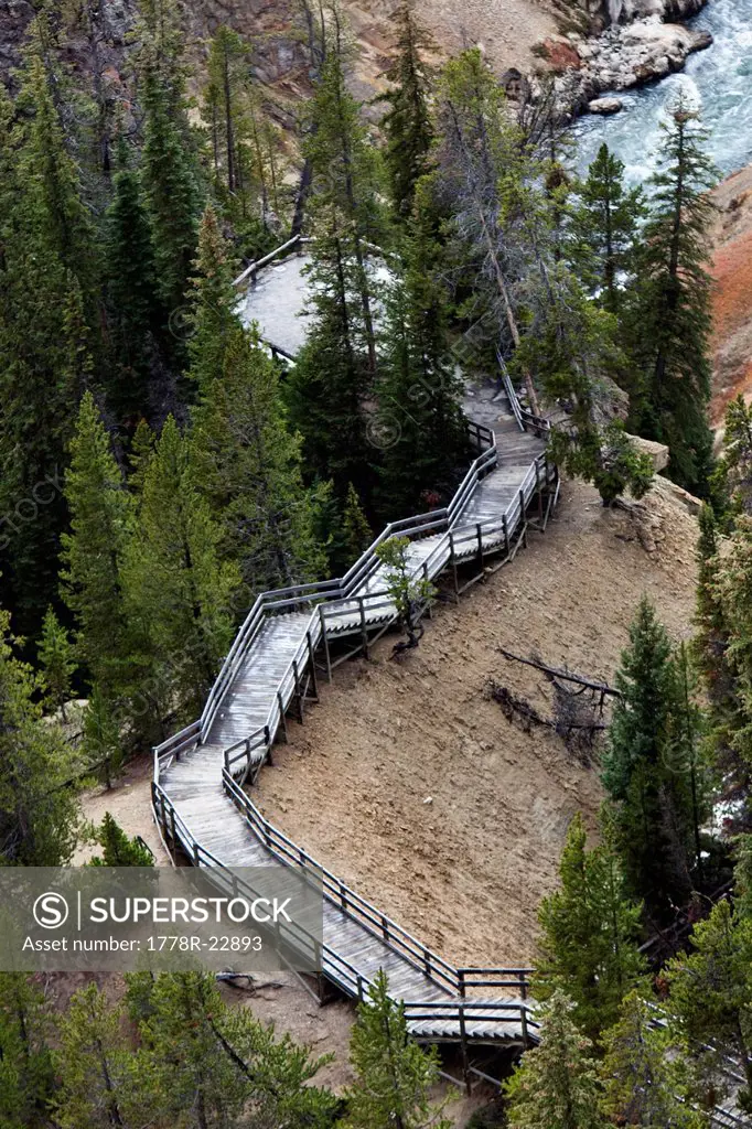 A narrow stair set winds down to a overlook of a river in Wyoming.