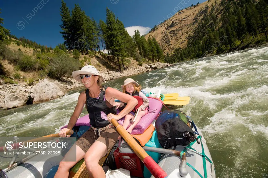 A mother and daughter rowing a raft through a rapid, Main Salmon River, Payette National Forest, Riggins, Idaho.