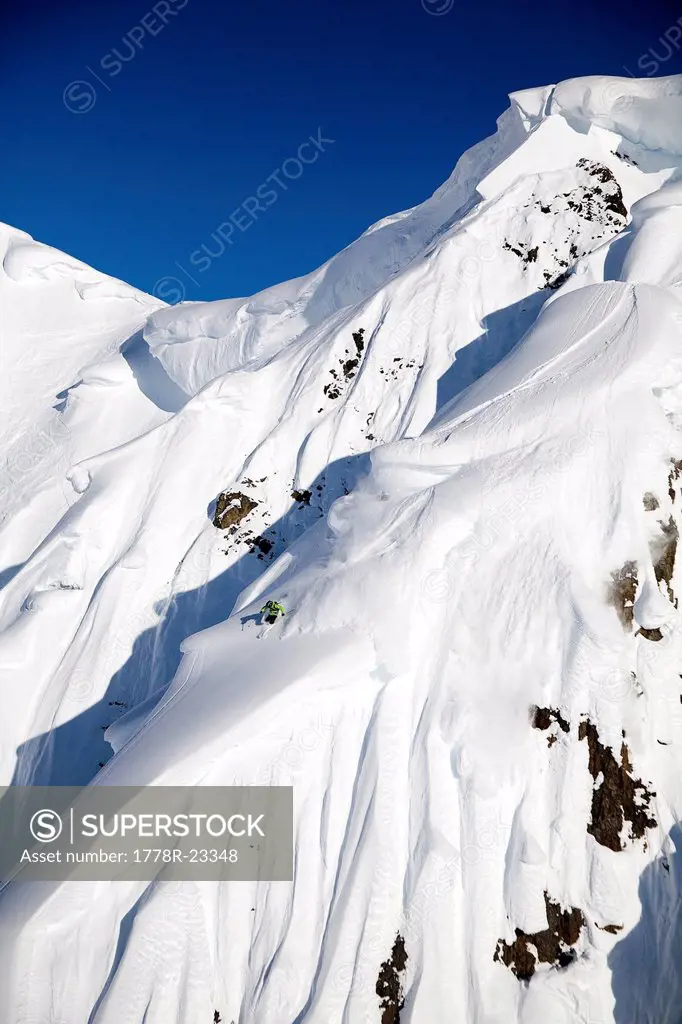A male skier skis a big first descent in Haines, Alaska.