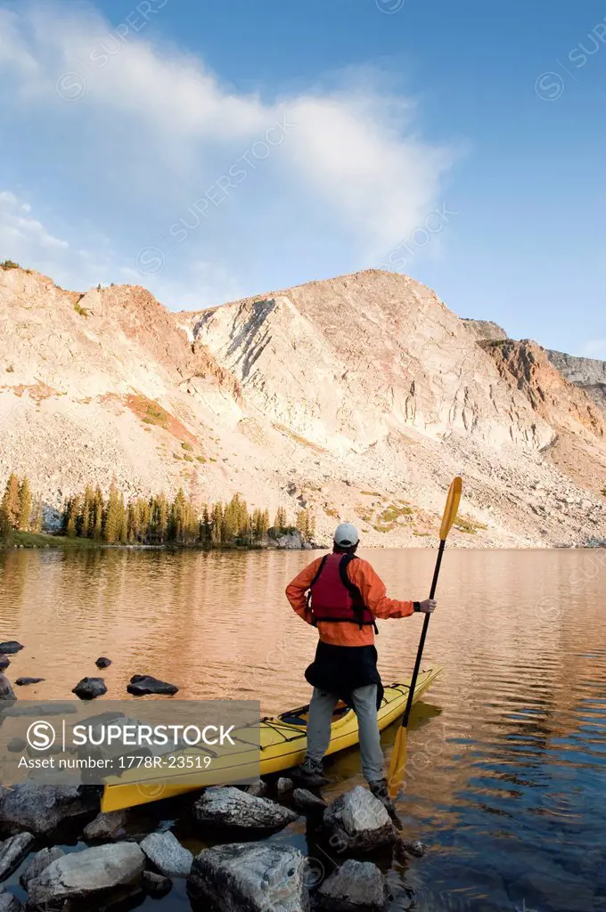 A man sea kayaking on Lake Marie in the Medicine Bow Mountains near Centennial, Wyoming.