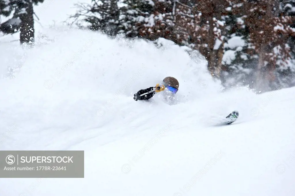 A man skiing through deep powder snow.
