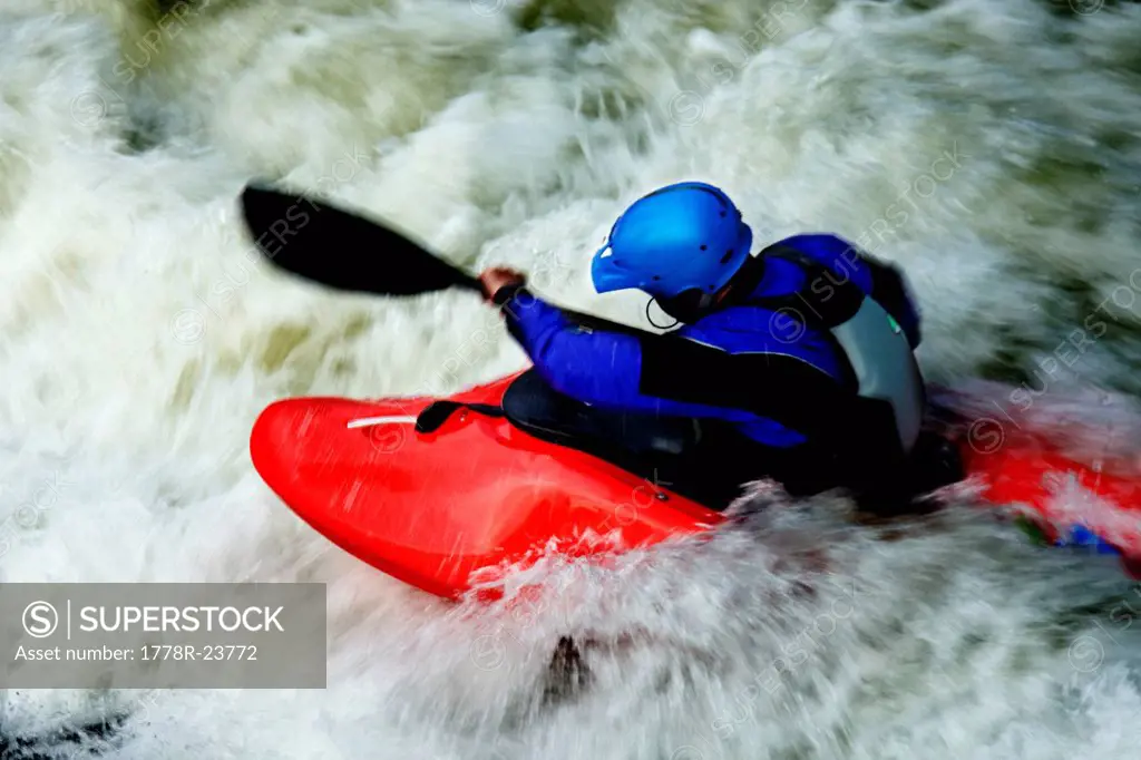 A male kayaker battles rapids on the Clark Fork River, Missoula, Montana.