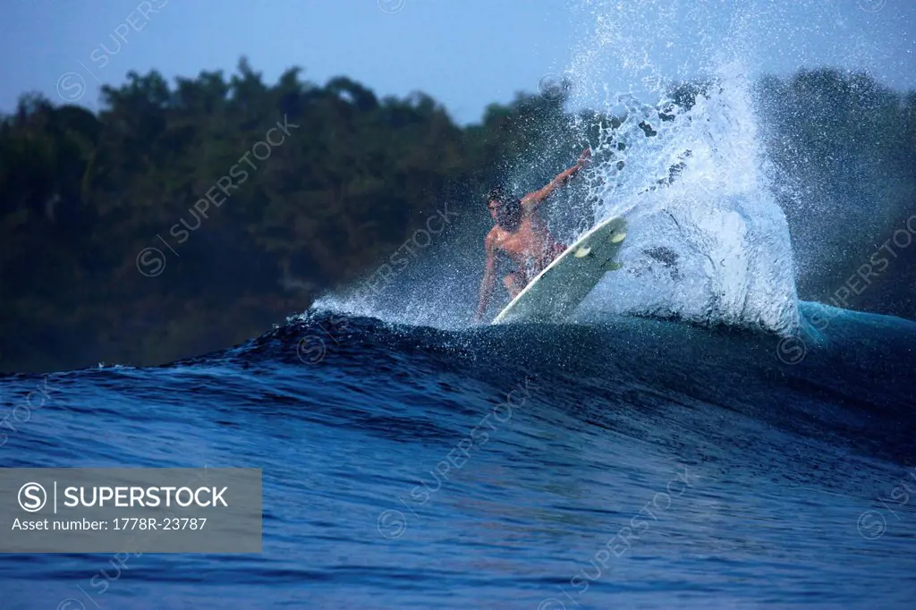 A surfer lands an aerial move at G_Land, Java, Indonesia.