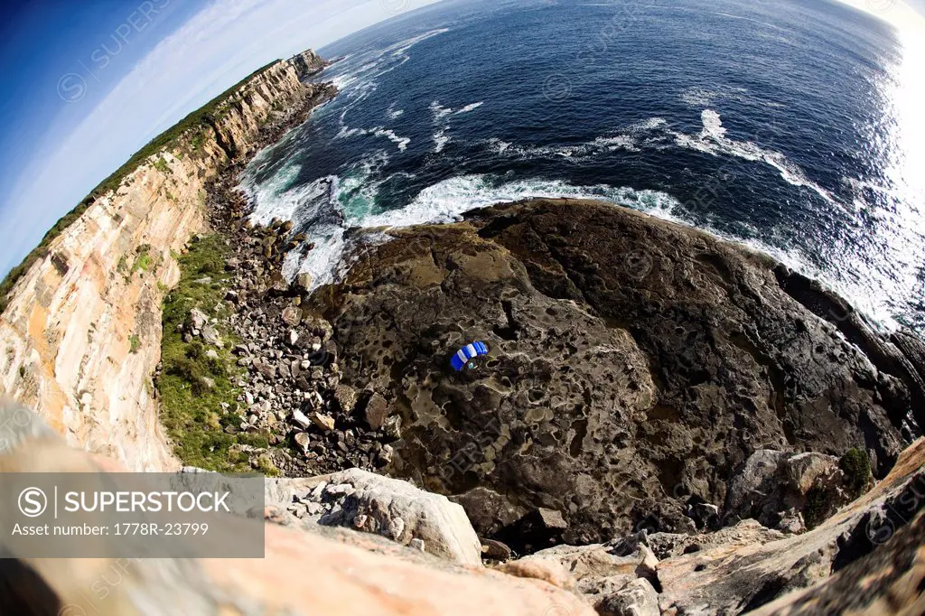 A BASE jumper glides his parachute to a landing in Sydney, New South Wales, Australia. fisheye lens.