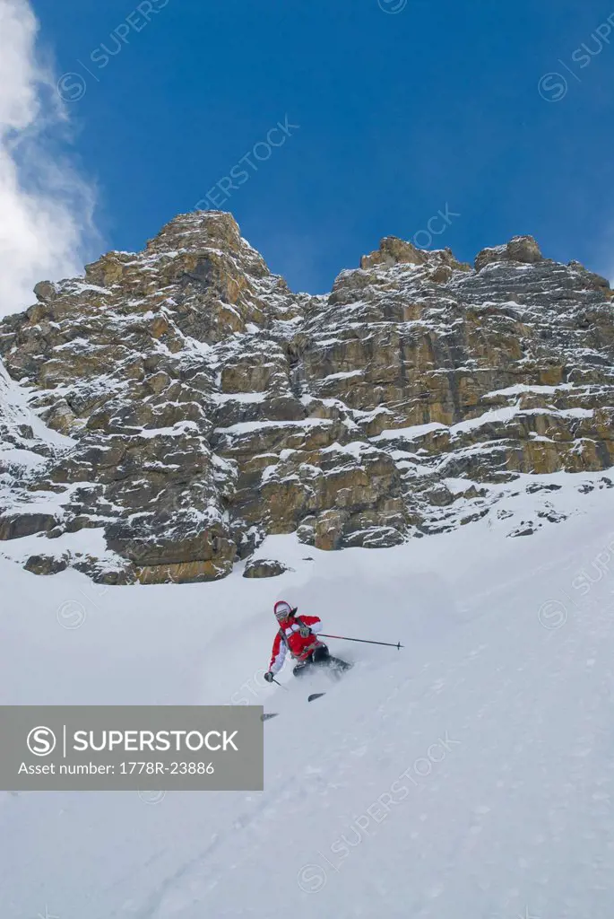 A woman skis a couloir in the Canadian Rockies.