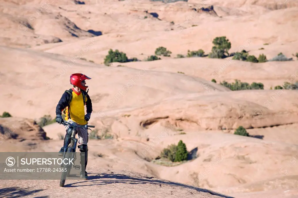 A mountain biker rests during a ride on the Slickrock Trail, Moab, UT.