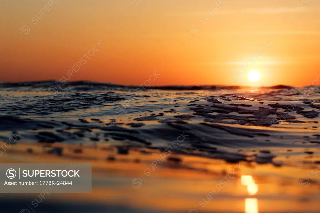 A colorful sunset over ripples and waves in Nicaragua