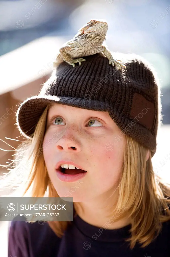 A boy poses with a bearded dragon while playing outdoors in Lake Tahoe, California.