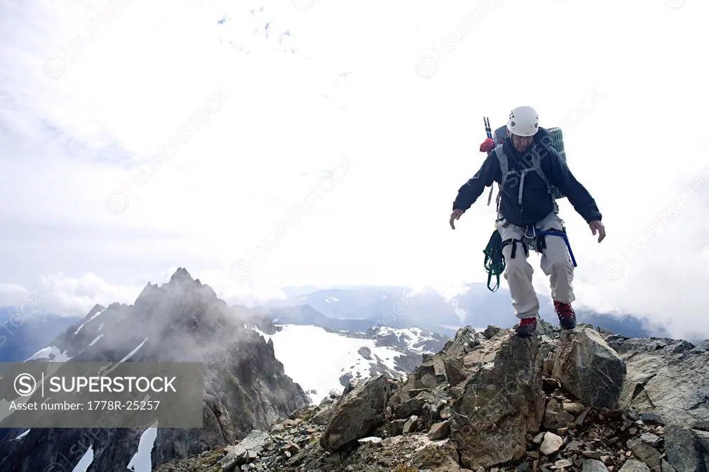 Climber on the summit of Mount Septimus, Strathcona Park, British Columbia.