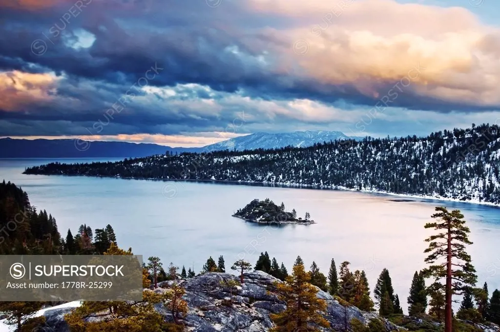 Clouds are illuminated at sunset over Emerald Bay in the winter, CA.