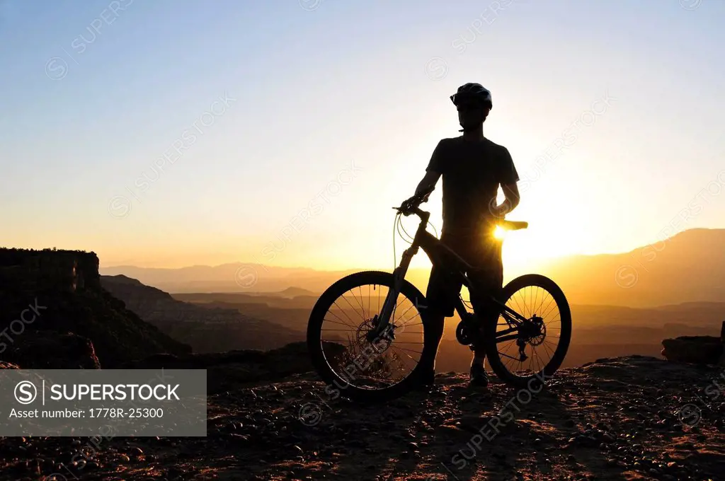 A silhouette of a mountain biker at sunset on Gooseberry Mesa in southern Utah.