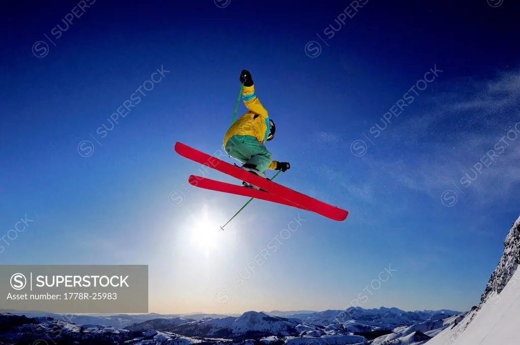 A skier soars through the air at sunrise in the Sierra Nevada mountains near Lake Tahoe, California.