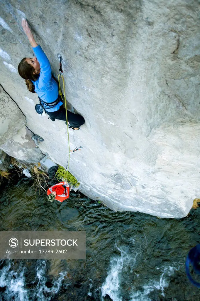 Climbing/belaying above a river.