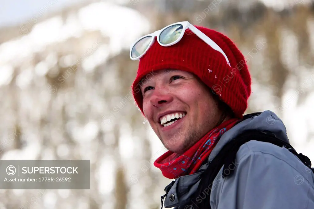 A happy skier smiling in the backcountry in Montana.