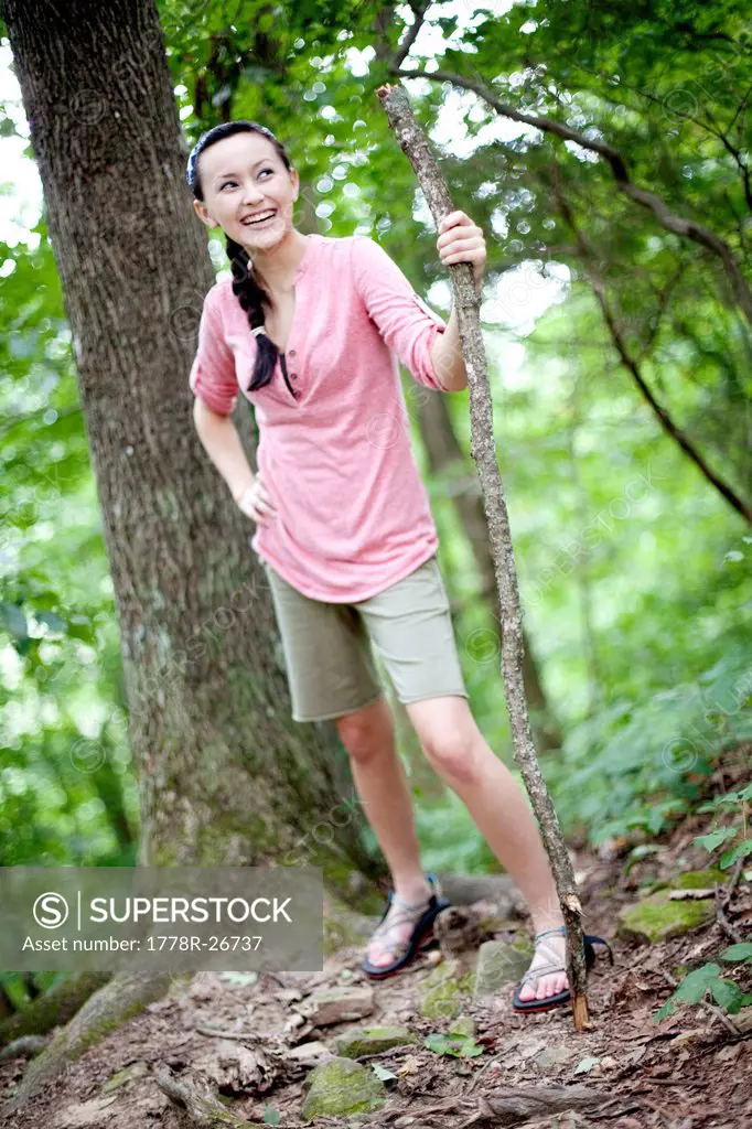 A young woman hikes up a trail.