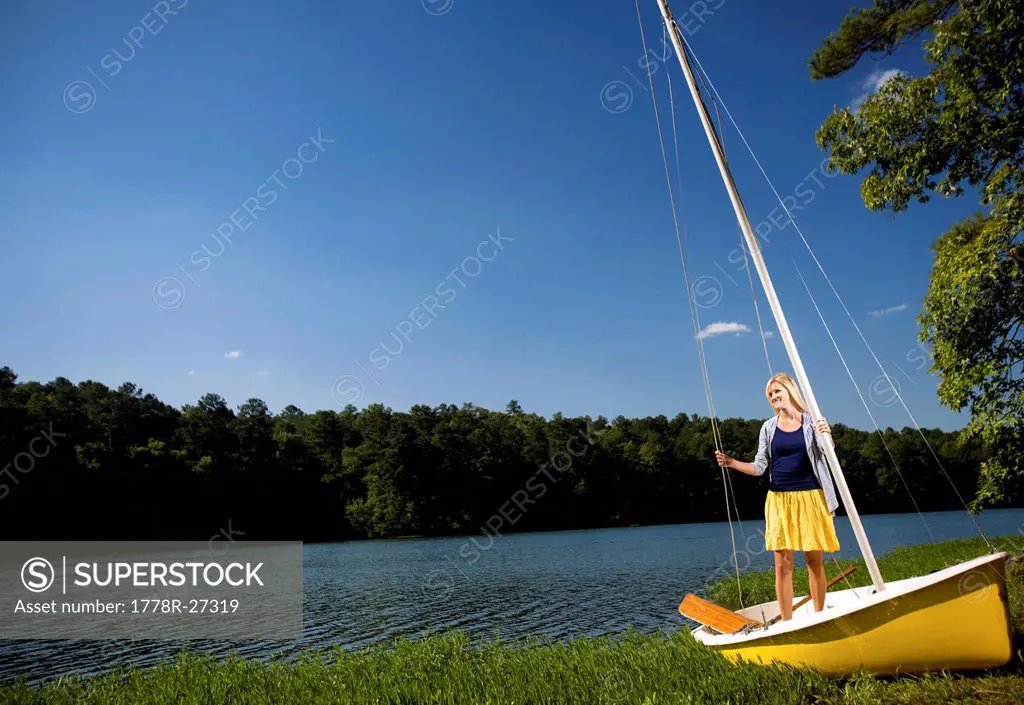 A young woman finishes sailing on a a lake in Alabama.