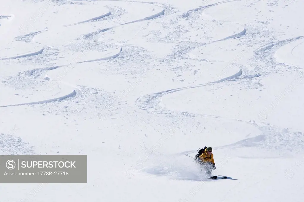 One man skiing a new line between other skiers´ tracks.