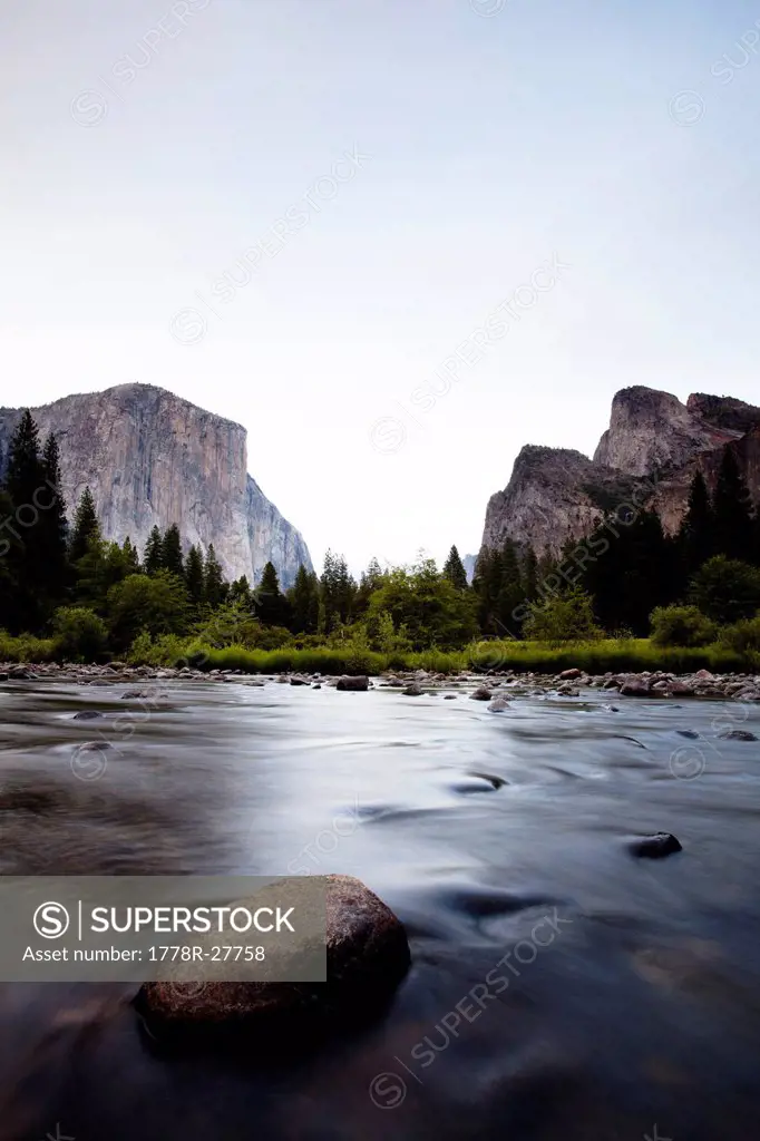 The Merced River gently flows through the gates of Yosemite Valley.