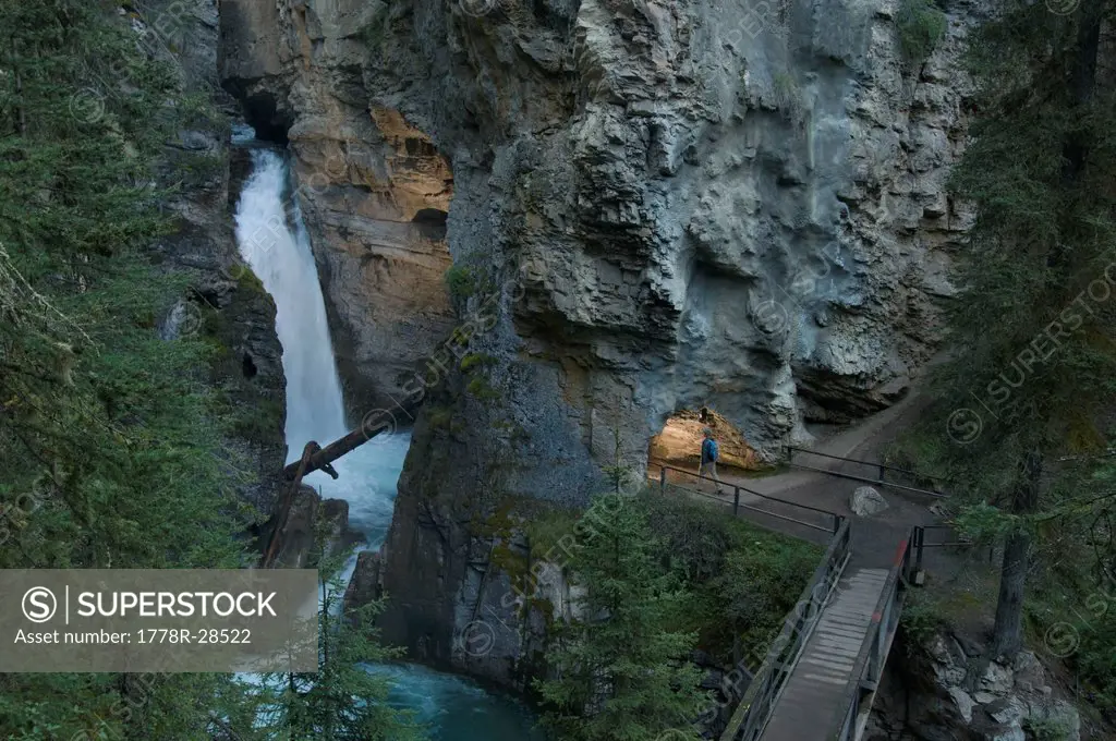 A man hiking to the Lower Falls of Johnston Canyon, Banff National Park, Banff, Alberta, Canada.