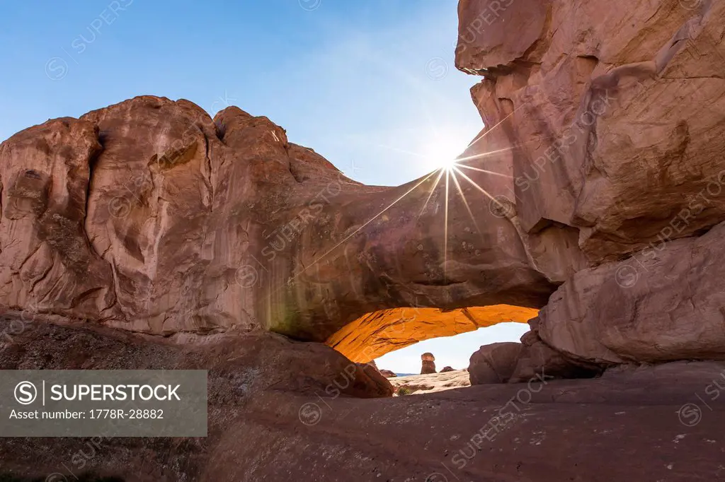 A natural rock arch in the desert.