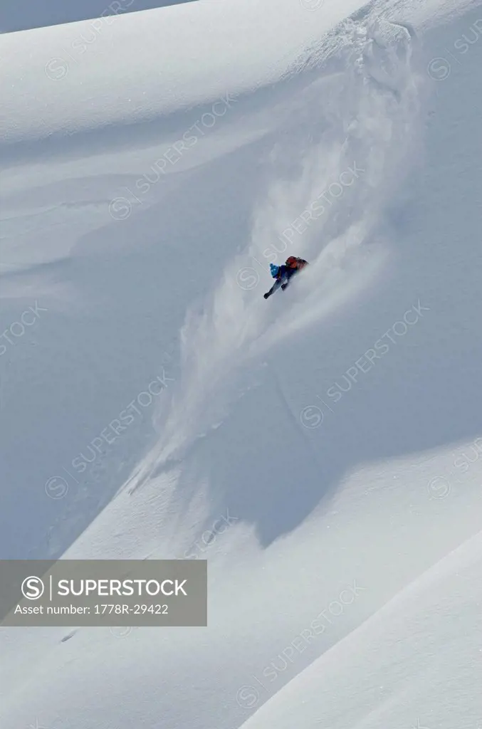 Steep skiing near a cornice.
