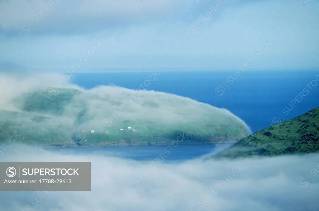 Mist and fog envelop the shoreline in the Faroe Islands, Denmark