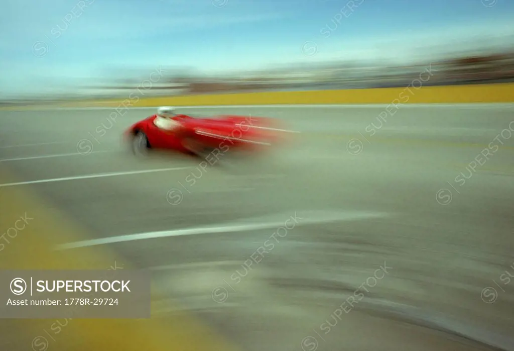 Vintage race car speeding down track,USA. (motion blur)