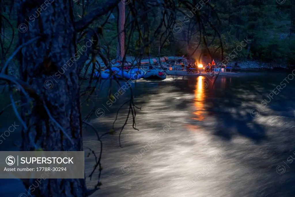 A river camp in the moonlight.