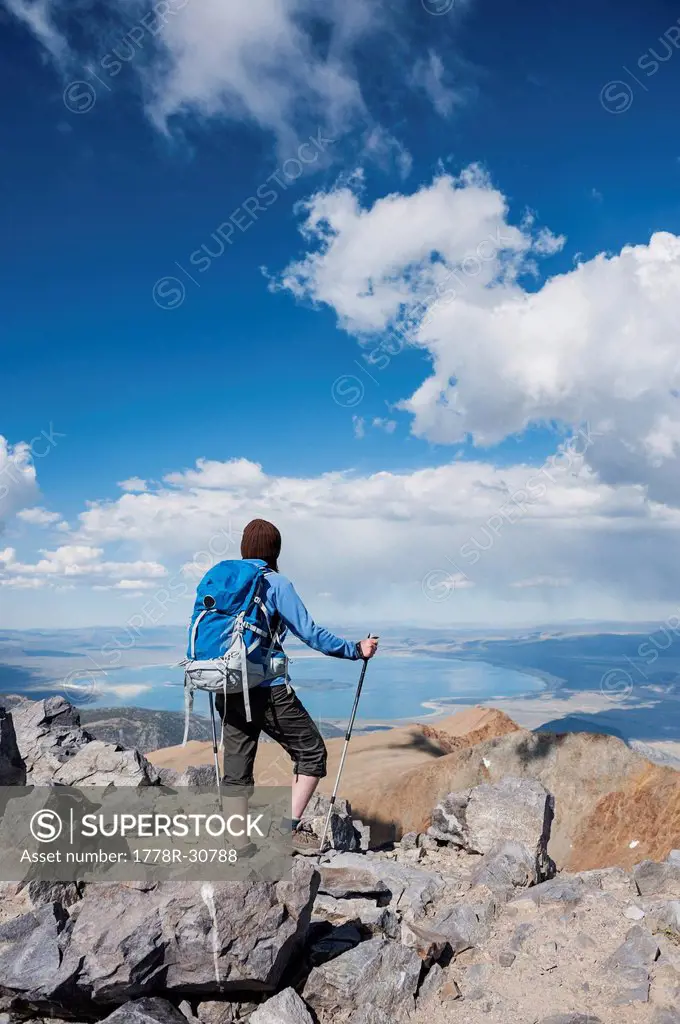Female hiker takes in view over Mono basin from summit of Mt. Dana (13,053 ft), Yosemite national park, California, USA
