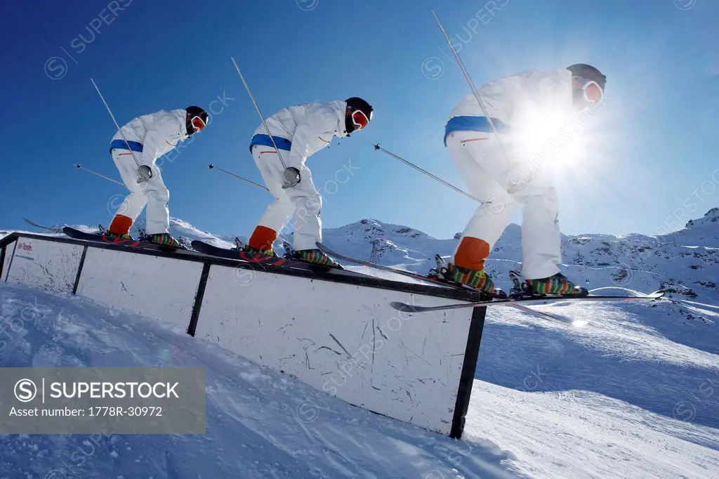 Skier practicing tricks on rails
