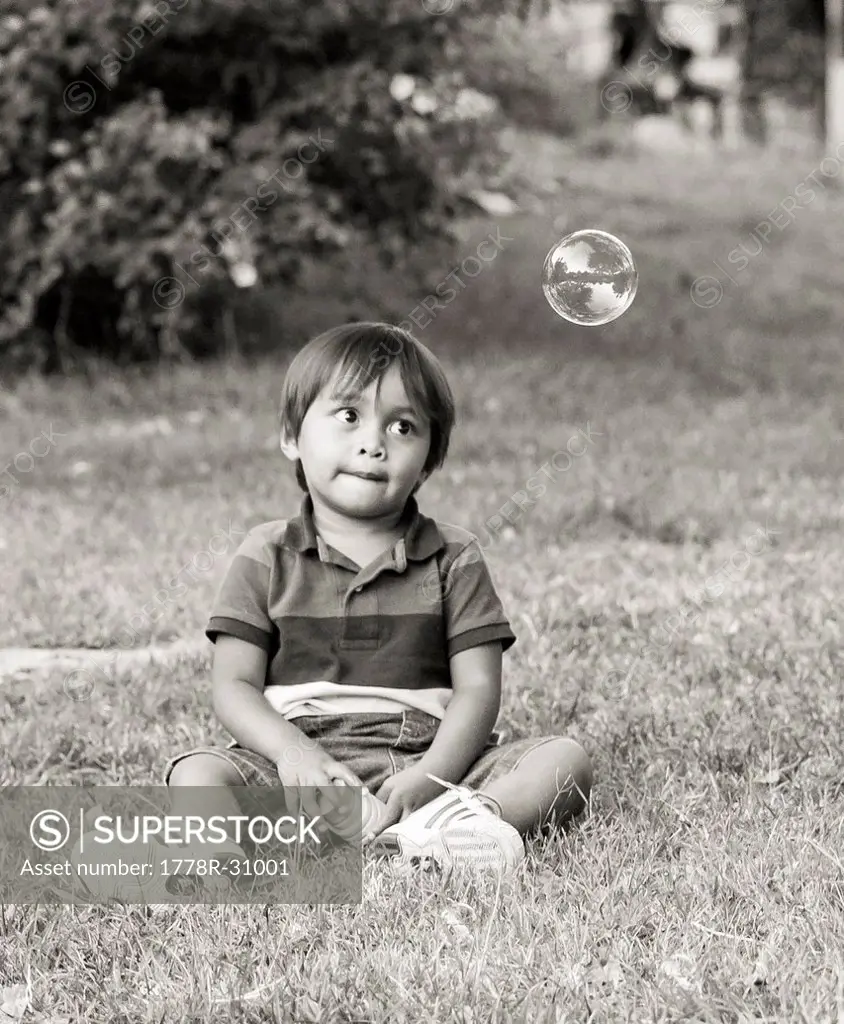 Small boy wating bubbles