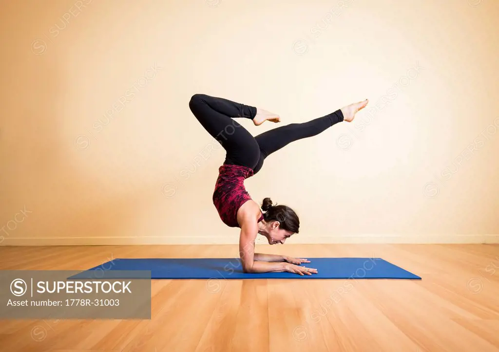 Young Woman practicing yoga in studio
