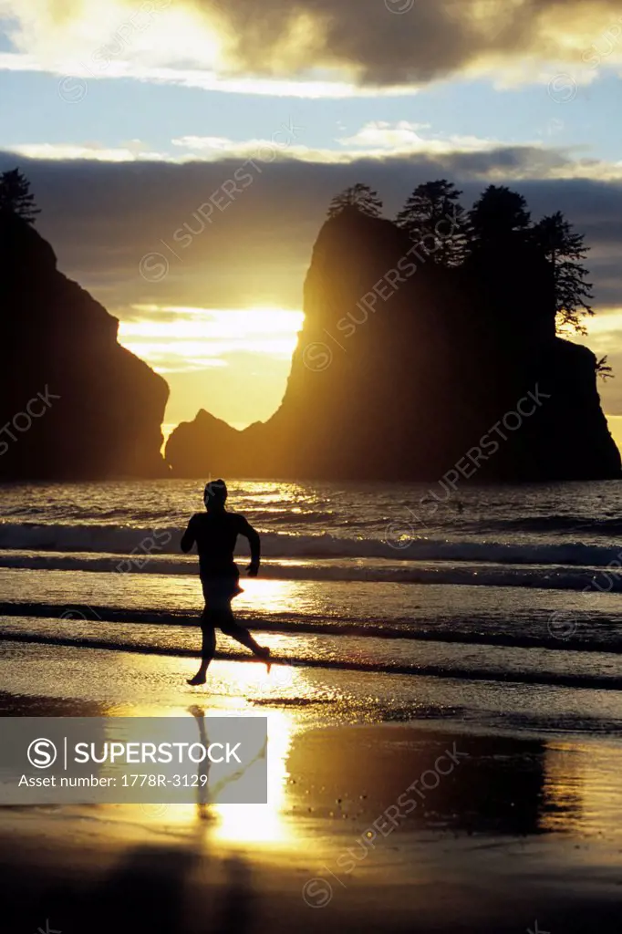 Runner at sunset on beach.