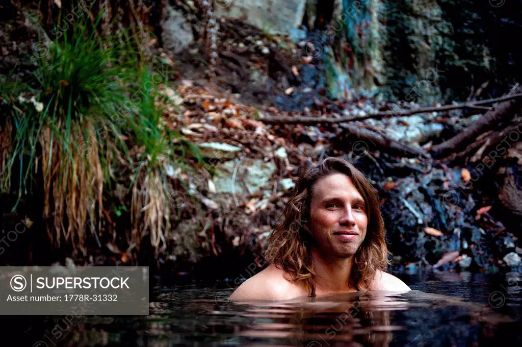 Man enjoys a hot spring in Big Sur, California.