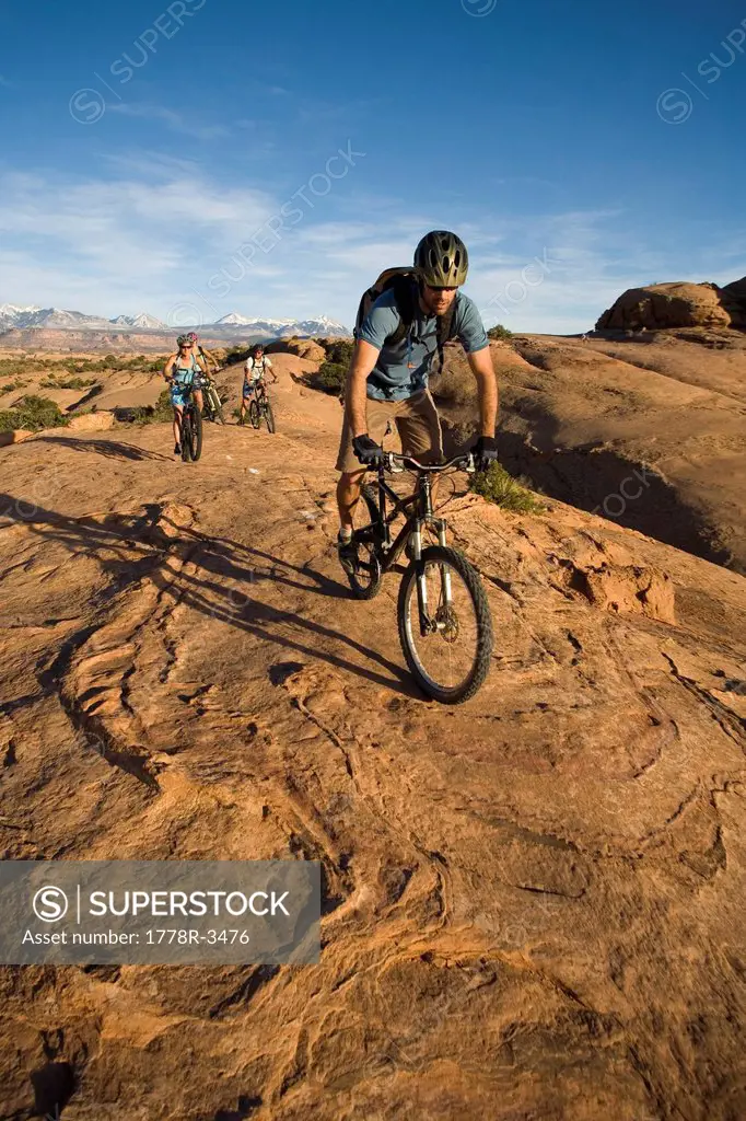 A group mountain biking in Moab, Utah.