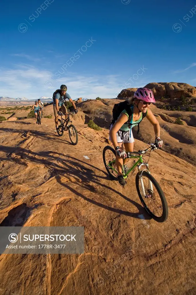 A group mountain biking in Moab, Utah.