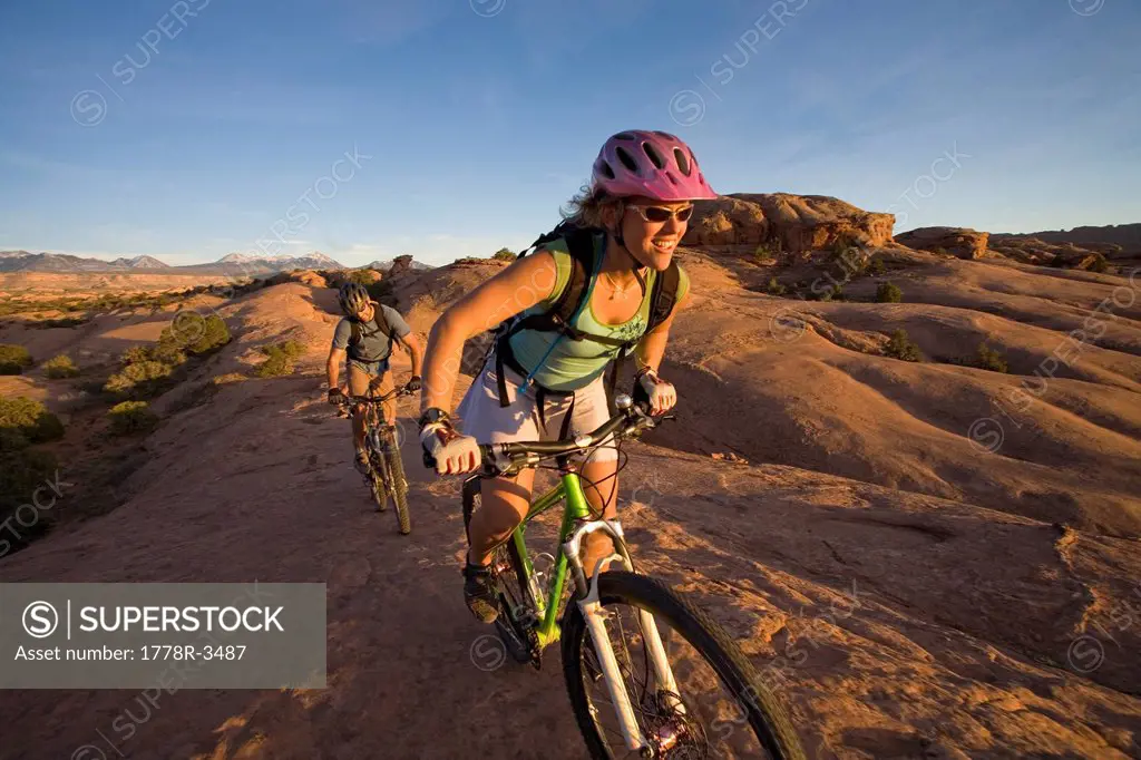 Couple mountain biking, Moab, Utah.