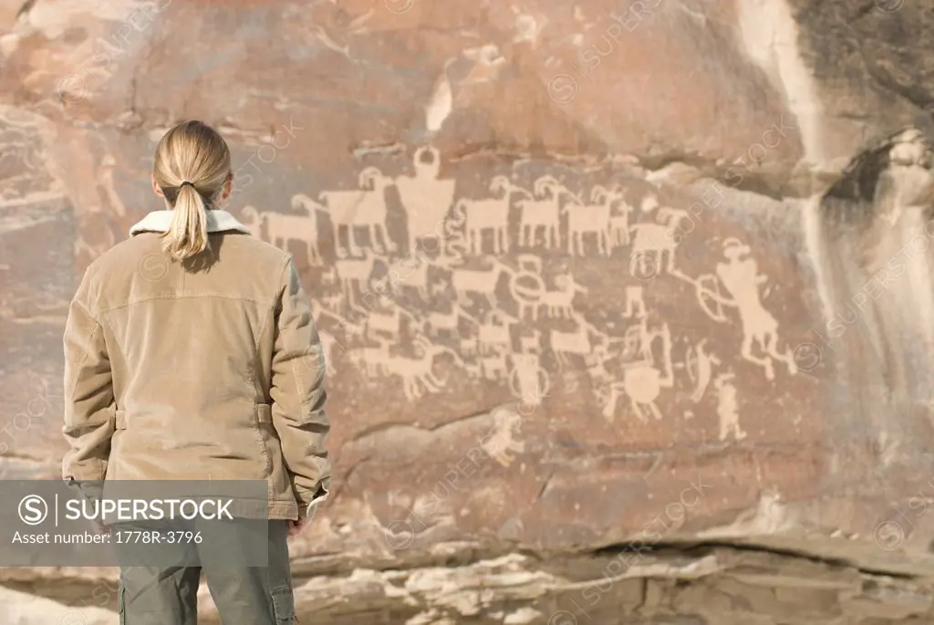 Woman looking at pictograph panel.
