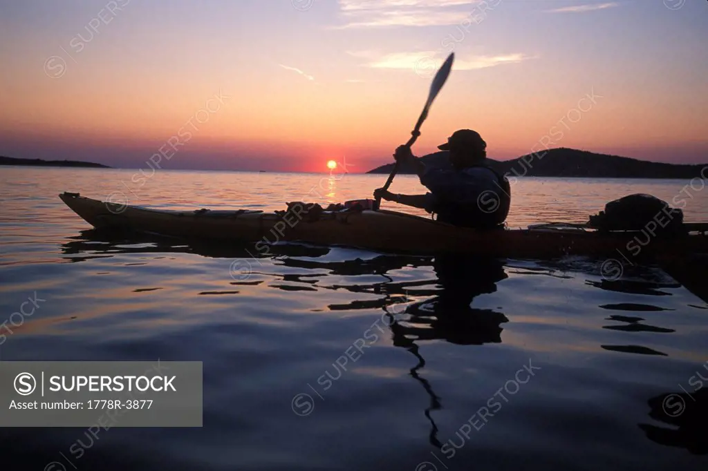 Kayaking at sunset in Croatia.