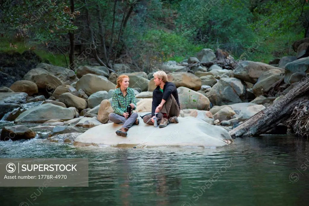 Backpackers taking a break at a river.