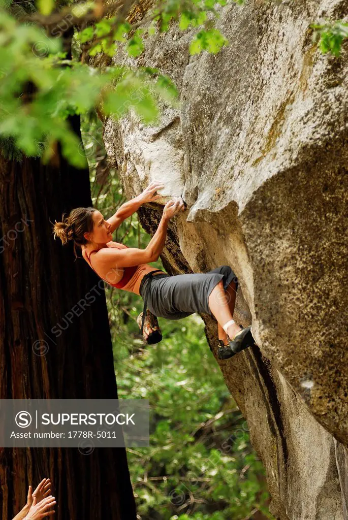A woman rock climbing in Yosemite Valley, California, USA.