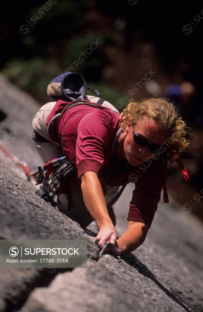 A woman gripping a crack while rock climbing in Squamish, British Columbia, Canada.