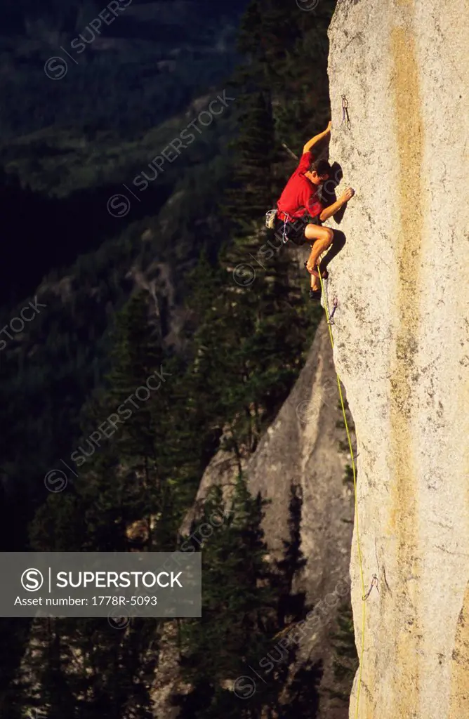 Man rock climbing at Squamish, British Columbia, Canada on a sunny day.