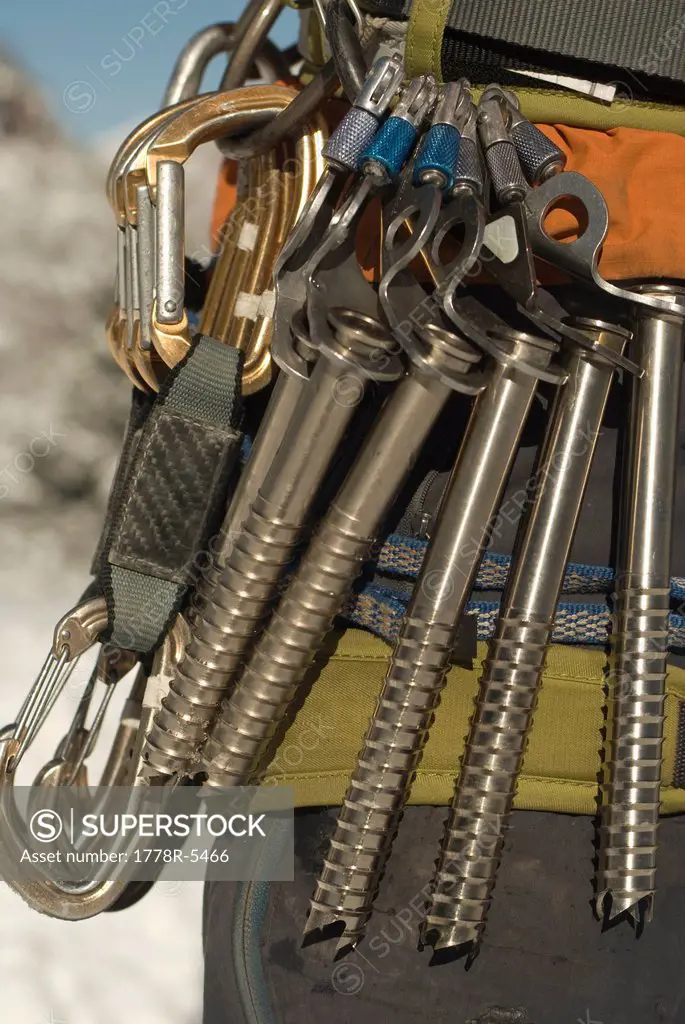 A close view of a climber´s ice screws and quickdraws, equipment needed to climb a frozen waterfall.