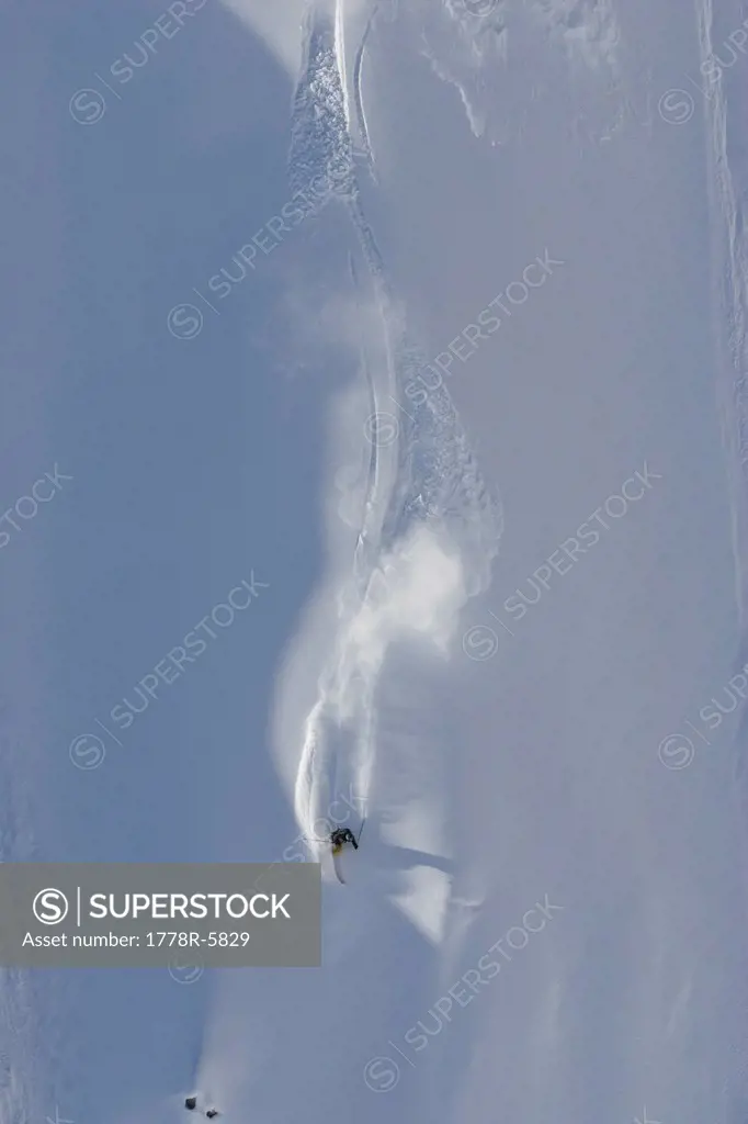 Skier shot from above making powder turns in the Tordillo Mountains, Alaska.